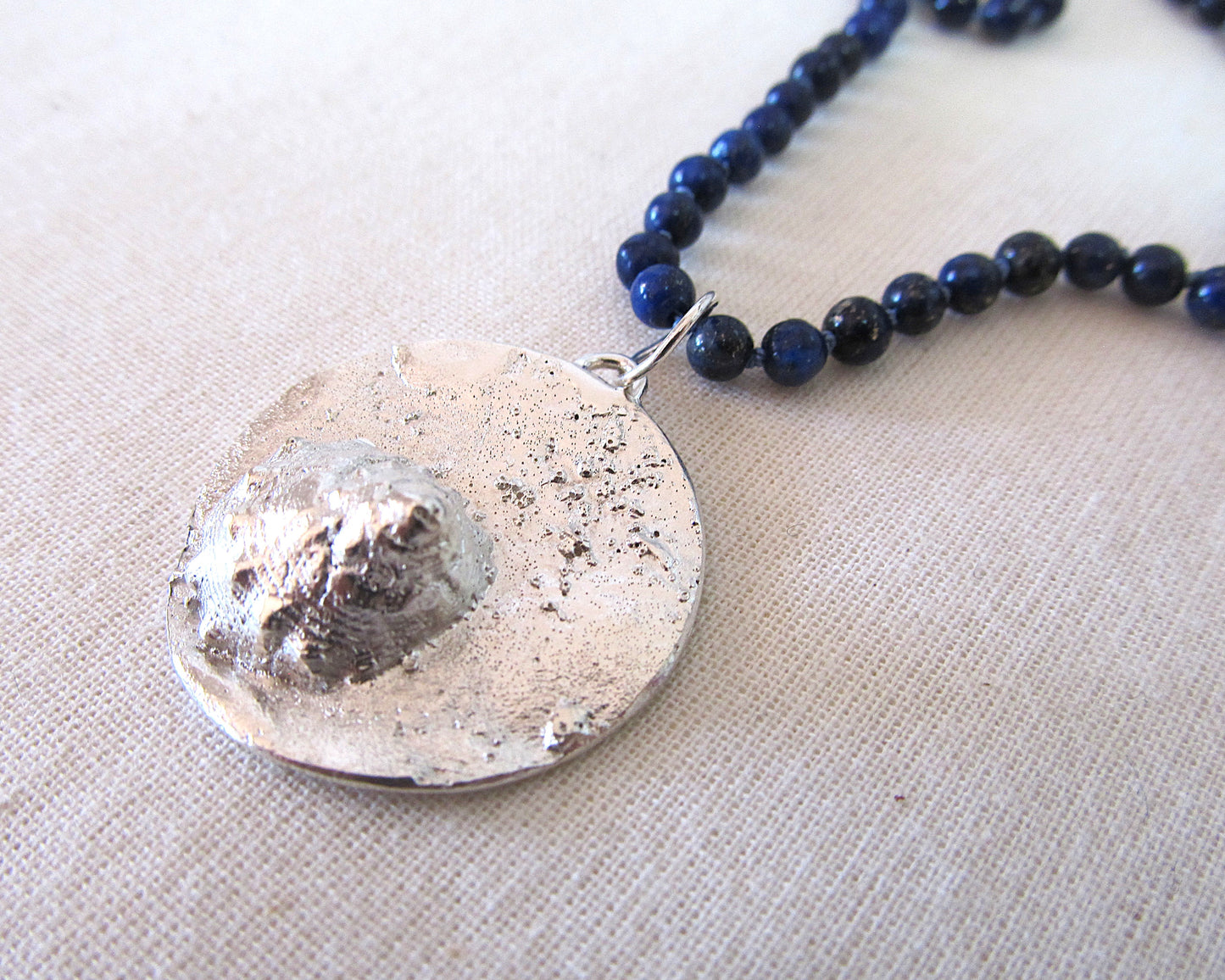 Contemporary silver shell and sea sand pendant